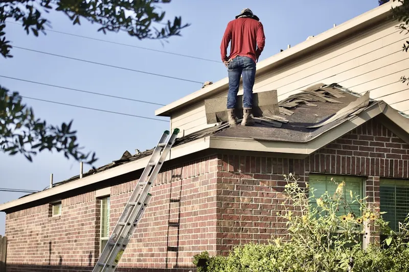 Professional roofer working on a residential roof in Rock Point